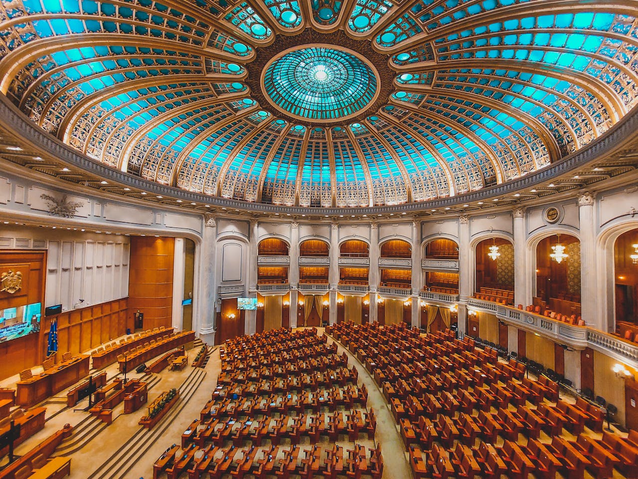 Home Vibrant interior of a parliament hall with a grand dome and intricate architecture.