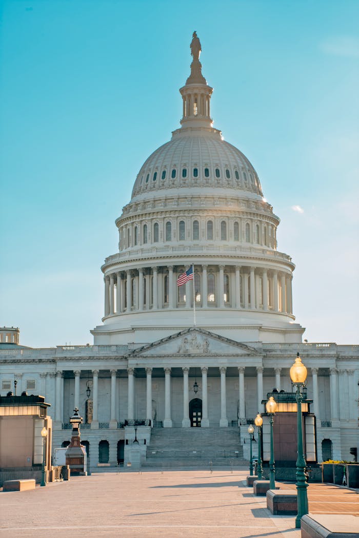 Home Stunning view of the United States Capitol building with bright sky, symbolizing American democracy and government.
